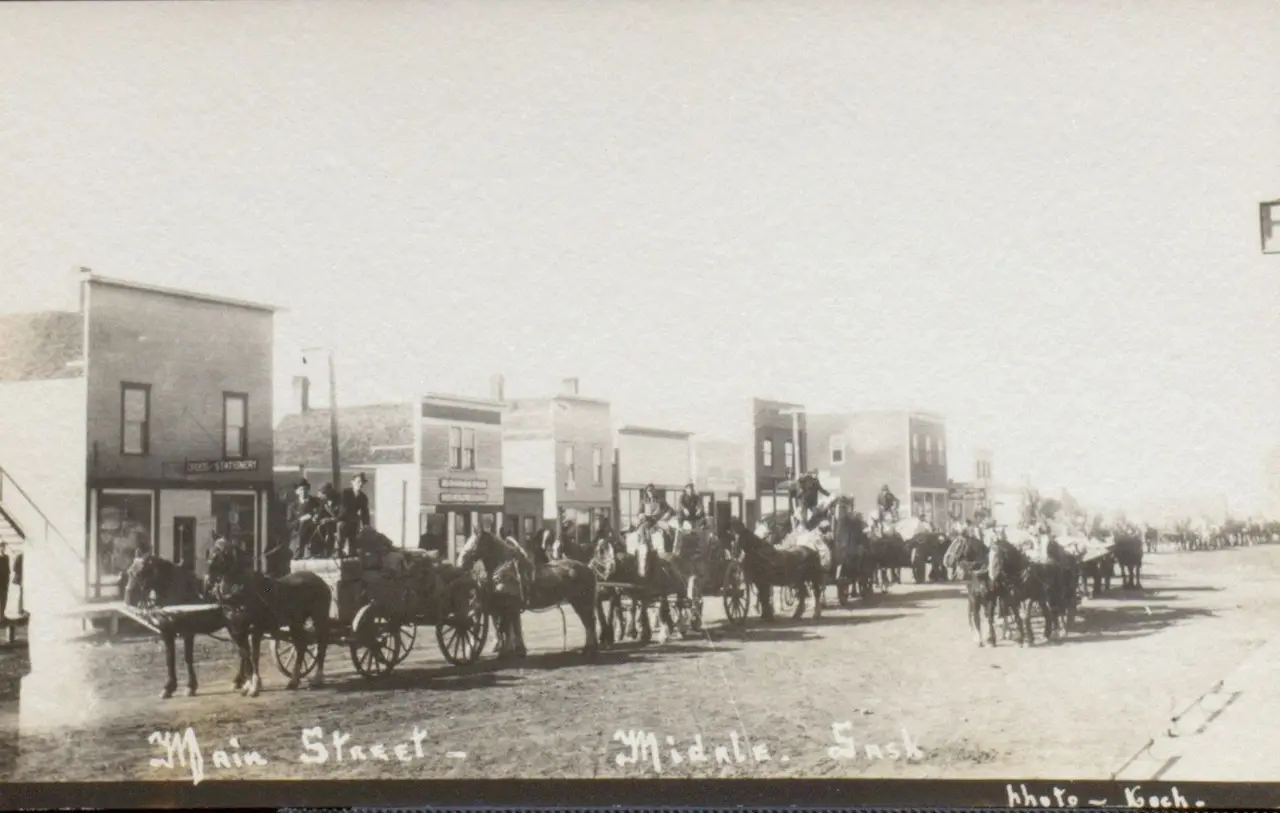 Main Street with a line of horse-drawn wagons, about 1910