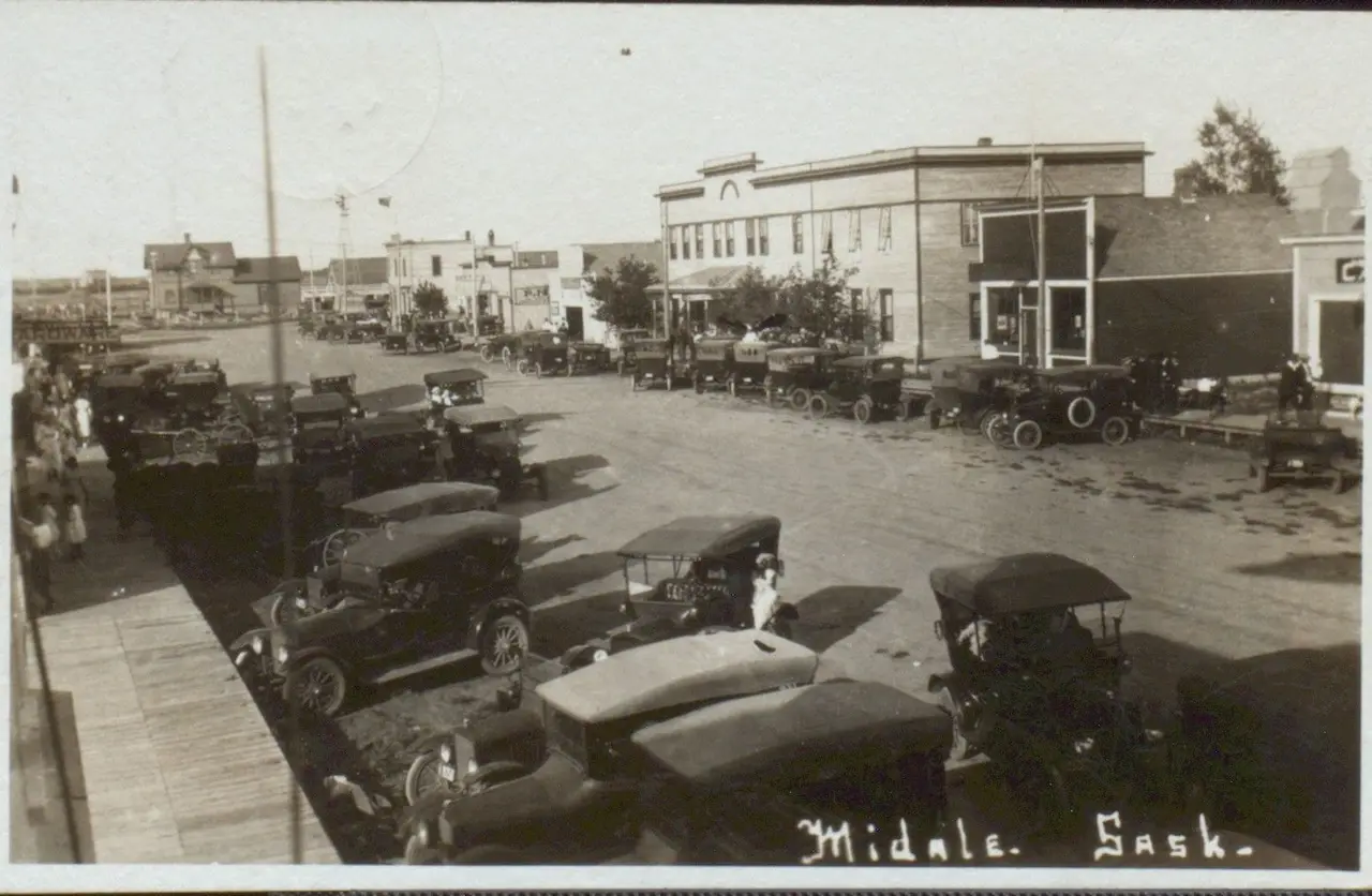 Main Street lined with parked cars, about 1920